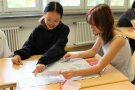 Jugendlicher sitzen am Tisch und spielen ein Spiel