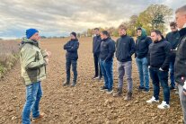 Leute stehen auf einem Acker